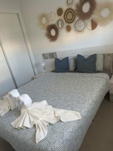 a bedroom with a bed with towels on it at Arenales SLB in Arenales del Sol +14 photos