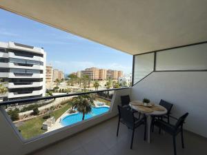 a balcony with a table and chairs and a pool at Arenales SLB in Arenales del Sol
