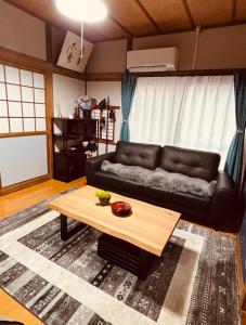 a living room with a couch and a coffee table at tazuraya-seto-一棟貸切-無料駐車場 in Takamatsu