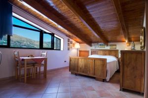 a bedroom with a bed and a table and a window at B&B Fasolino in Castellabate