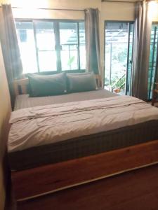 a large bed in a room with a window at เฌอPrime Cher Prime by Tree house Maelai in Ban Pok Nai