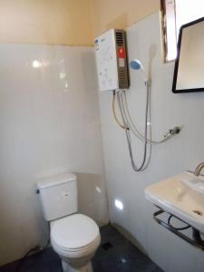 a bathroom with a toilet and a sink at เฌอPrime Cher Prime by Tree house Maelai in Ban Pok Nai