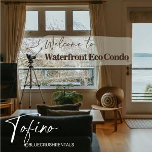 a living room with a camera in front of a window at Tofino Eco Waterfront Condo in Tofino