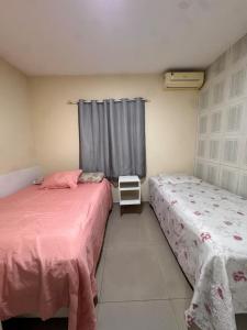 Ένα ή περισσότερα κρεβάτια σε δωμάτιο στο Casa com Piscina na Grande Florianópolis +27 φωτογραφίες