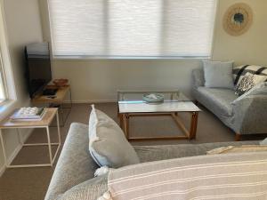 a living room with a couch and a coffee table at 20 Bradley in Coles Bay +11 photos