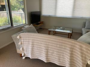 a living room with a couch and a table at 20 Bradley in Coles Bay