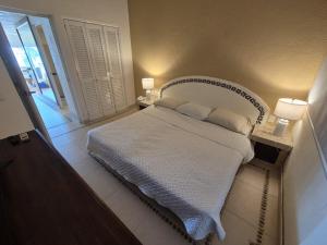 a bedroom with a white bed with two pillows at Luxury Beachfront Condo at Iguana-Ixtapa in Ixtapa