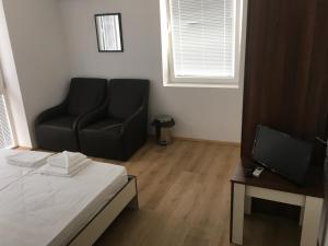 A television and/or entertainment centre at By The River Hotel