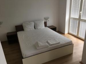 A bed or beds in a room at By The River Hotel