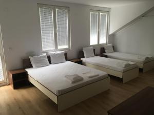 A bed or beds in a room at By The River Hotel