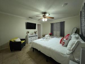 Un dormitorio con una cama y un ventilador de techo. en Sunshine Nest, en Lehigh Acres