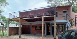 a house with a balcony on top of it at Large Duplex #1 in San Bernardo