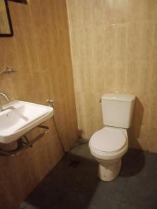 a bathroom with a white toilet and a sink at เฌอPrime Cher Prime by Tree house Maelai in Ban Pok Nai