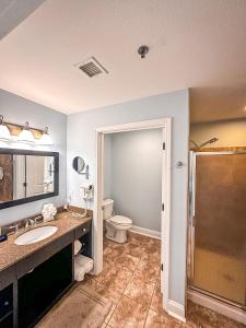 a bathroom with a toilet and a sink and a shower at Fairway To Heaven At Four Season 2bed2bath Condo in Lake Ozark