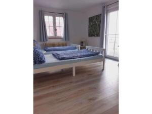 Dos camas en una habitación con suelo de madera. en Holiday home with 1 bedroom, en Friesenheim