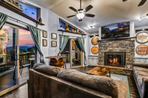 a living room with a couch and a fireplace at Distiller's Den in Gatlinburg
