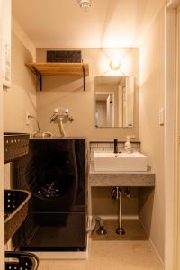a bathroom with a sink and a mirror at The Residence Sapporo - すすきの駅から徒歩6分 - in Sapporo