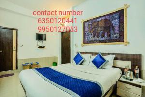 SPOT ON Dream Land Desert Camp في جيلسامر: غرفة فندق بها سرير ورقم هاتف