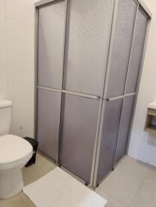 a shower stall in a bathroom with a toilet at Apartamentos modernos próximos a tudo in São Gabriel