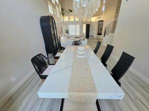 uma sala de jantar com uma mesa e cadeiras brancas em Modern Residence with Mountain Views em Escondido