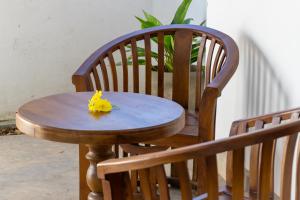 een houten tafel met een geel stuk papier erop bij Margosa Ahangama in Ahangama