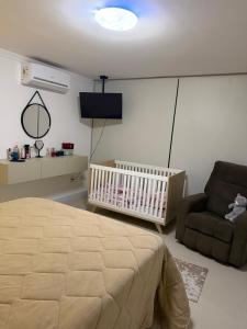 Giường trong phòng chung tại Suíte Pé na Areia