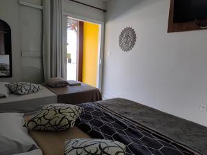 En eller flere senge i et værelse på Pousada X + 36 billeder