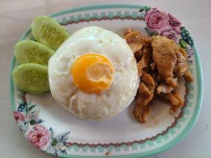 a plate of food with an egg and fried meat at Siriporn Resort Koh Chang in Ko Chang
