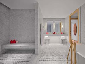 a bathroom with a tub and a shower with two sinks at Faena New York in New York +77 photos