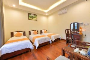 Postel nebo postele na pokoji v ubytování Paradise Boutique Hoi An