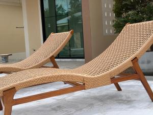 two wicker chairs sitting next to each other at Pinky Bungalow Resort & Villa - SHA Extra Plus in Ko Lanta