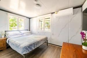 a bedroom with a large bed and two windows at Overlooking a Park - A sunny escape in Rooty Hill