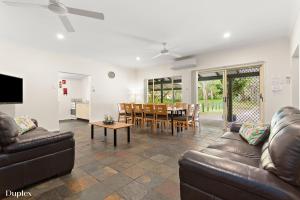 a living room with a couch and a table at The Retreat Port Stephens in Anna Bay