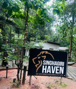 a sign for a singaporeanhaven in front of a tree at Singhagiri Haven Sigiriya in Sigiriya +51 photos