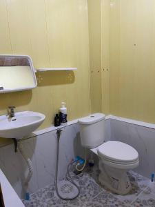 une salle de bains avec toilettes et lavabo dans l'établissement Home Stay 1, à Kratie