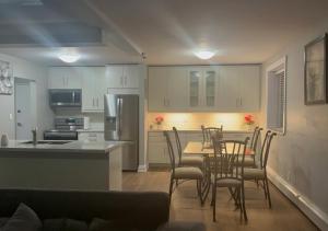 a kitchen and dining room with a table and chairs at Luxurious Two Bedroom Apartment in Burlington +16 photos