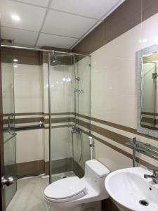 a bathroom with a shower and a toilet and a sink at Four P Home and Studio in Ho Chi Minh City +34 photos
