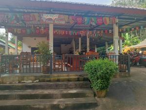 a building with a gate and stairs in front at Grand Bungalow in Ban Ting Rai