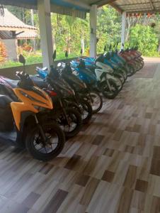 una fila di motociclette parcheggiate l'una accanto all'altra di Grand Bungalow a Ban Ting Rai
