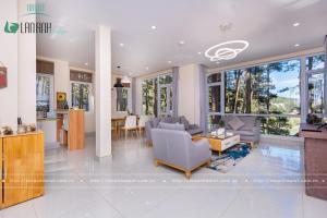 a living room with a couch and chairs and windows at Lan Anh Villas Resort in Da Lat