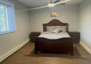 a bedroom with a bed and a ceiling fan at Luxurious Two Bedroom Apartment in Burlington