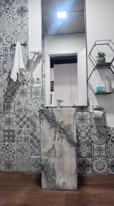 a bathroom with a sink and a tiled wall at Twins apartment delux 2, new gudauri in Gudauri +20 photos