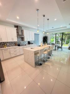a large kitchen with a large table and chairs at Tropical Oasis in Naples