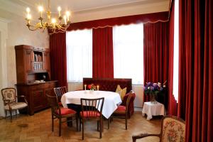 a dining room with a table and red curtains at Land-gut-Hotel Allerhof in Frankenfeld