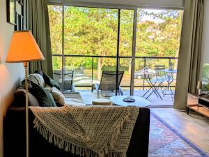 a living room with a couch and a large window at La Parent-aise in Thionville +36 photos