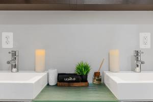 a bathroom with two sinks and a potted plant at Luxe Logan Circle Escape - Near Downtown DC & Shaw in Washington +40 photos