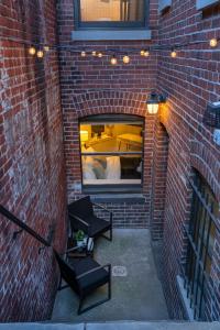 a brick wall with a patio with a table and benches at Luxe Logan Circle Escape - Near Downtown DC & Shaw in Washington