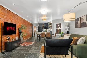 a living room with a brick wall at Luxe Logan Circle Escape - Near Downtown DC & Shaw in Washington