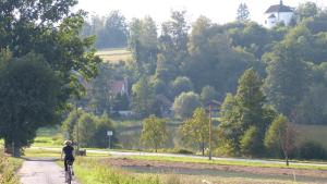 a person riding a bike down a dirt road at Penzion Pod Jáchymem in Dobrá Voda