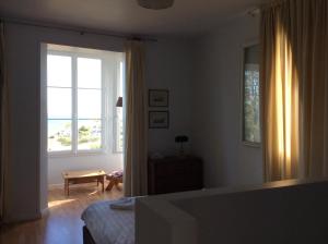 a bedroom with a bed and a large window at Auberge du Vieux Puits in Dieppe